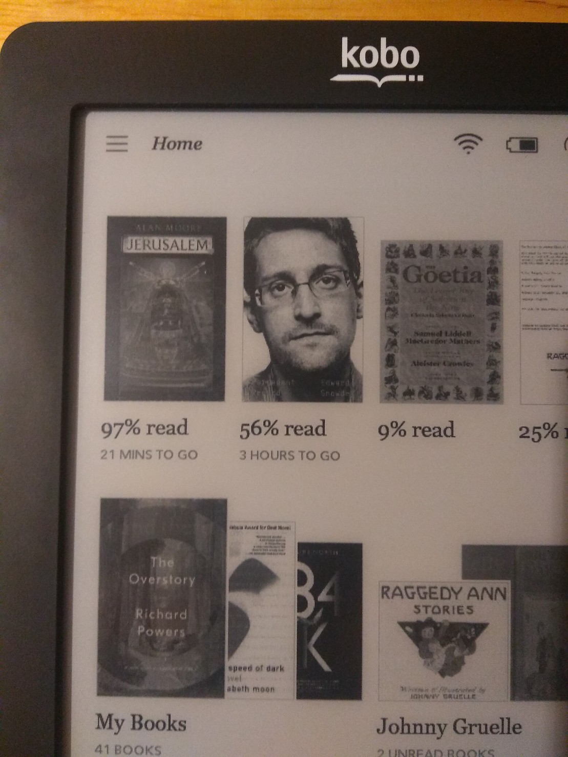 A photo of one corner of my e-reader showing partially-read books